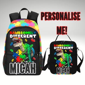 May include: Black backpack and lunch bag set featuring a green dinosaur with puzzle pieces. The backpack has a colorful puzzle piece pattern on the top. Text on both items reads "RAWRSOMLY DIFFERENT" and "MICAH".