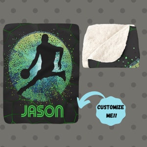 May include: Black and green fleece blanket with a silhouette of a basketball player dribbling a ball in a green and blue circle. The name "JASON" is printed in green letters at the bottom of the blanket.