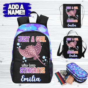 May include: A black backpack, drawstring bag, lunch bag, and pencil case set. Each item features a pink stingray graphic with the text "JUST A GIRL who loves STINGRAYS Emilia" against a black background. The backpack has a purple and blue bubble pattern.