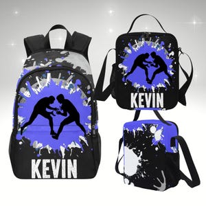 May include: A black and blue backpack, lunch bag, and small bag set. Each item features a silhouette of two wrestlers in action on a blue splatter design. The name "KEVIN" is printed in white block letters on each bag.