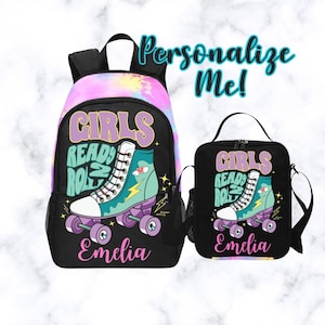 May include: A black backpack and lunch bag set featuring a roller skate design. The backpack has a colorful tie-dye top and the text "Girls Ready 2 Roll" and "Emelia". The lunch bag has the same design and text. The words "Personalize Me!" are in the background.