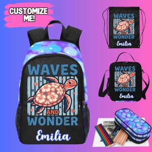 May include: A black backpack, drawstring bag, and lunch bag set with a sea turtle design. The backpack has a blue and purple bubble pattern on the top. The bags feature the text "Waves and Wonder" and the name "Emilia".