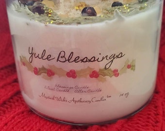 May include: A white candle in a clear glass jar with a green and red holly design and the text "Yule Blessings". The candle is labeled "Blessings Candle, Ritual Candle, Alter Candle, Mystical Wicks, Apothecary Candles, 14 oz."