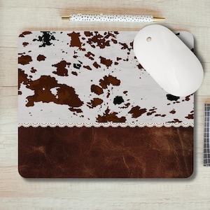 May include: Cowhide print mouse pad with a brown leather bottom and a white lace trim.