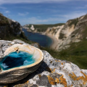 Natural shell with resin ocean and sunbathing figure
