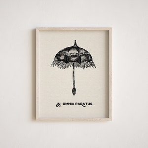 May include: Black and white illustration of a vintage umbrella with a fringed border. The text "In Omnia Paratus" is printed below the umbrella.