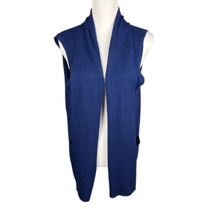 May include: A sleeveless blue cardigan with a long, open front and a shawl collar.