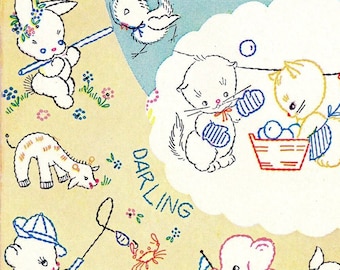 May include: A vintage-style iron-on transfer sheet featuring a whimsical illustration of animals and a train. The illustration is in a light blue and yellow color scheme with a cloud-shaped border. The text "NEW HOT IRON TRANSFERS REPRINTED FROM VINTAGE PATTERNS!" is at the top of the sheet.