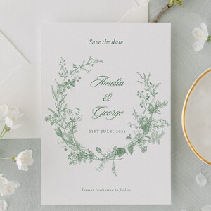 Save the date sage green template with a crest and wildflower design