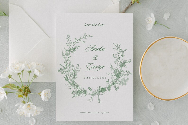 Save the date sage green template with a crest and wildflower design