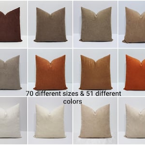 May include: A selection of cushions in shades of brown, beige, and orange. The image showcases a range of cushion colours and textures. Text on the image reads "70 different sizes & 51 different colours."
