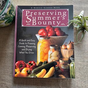 May include: A Rodale Garden Book titled "Preserving Summer's Bounty" with text about freezing, canning, preserving, and drying. The cover features images of tomatoes, jars of preserved foods, and fresh vegetables.