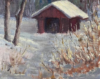 May include: A red wooden shed with a white snow-covered roof stands in a snowy landscape. The shed is surrounded by bare trees and tall grasses covered in snow. The ground is covered in a layer of white snow.