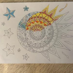 May include: A hand-drawn mandala design with a sun and moon motif. The sun is yellow and orange with a red center, and the moon is blue and green with a white center. The mandala is surrounded by a border of stars.