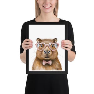 Cute whimsical capybara with heart glasses and bowtie Framed poster