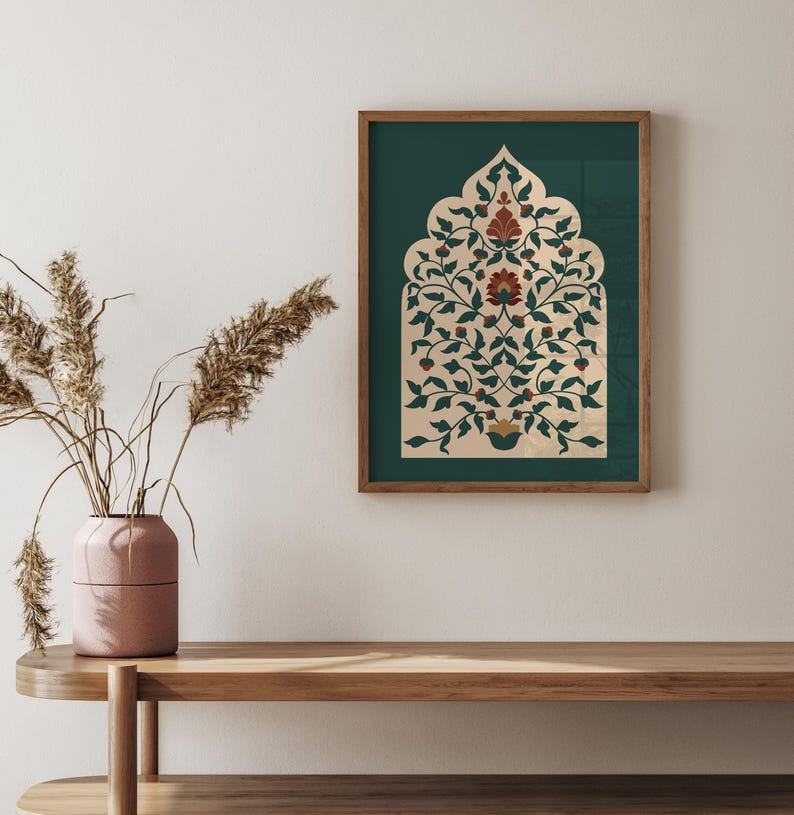 May include: A framed print featuring an ornate floral design in shades of cream, green, and red. The artwork is set against a dark green background and framed in a wooden border. The print is displayed on a wooden shelf.