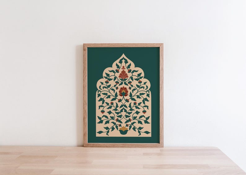 May include: A framed art print featuring an ornate floral design in shades of beige, red, and green against a dark teal background. The artwork is displayed in a natural wood frame, resting on a light wood surface.