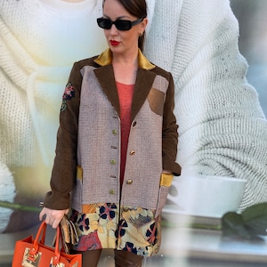 May include: A brown, plaid, and floral patchwork coat with a gold collar and a brown leather handbag.