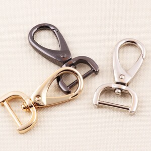 Puede incluir: Tres cierres giratorios de metal en dorado, plateado y negro.