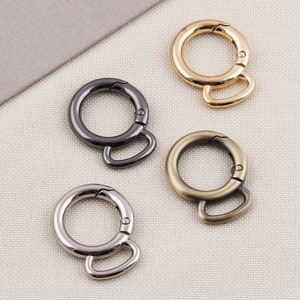 May include: Four metal swivel clasps in different finishes: gold, silver, antique brass, and black. These clasps are great for attaching to bags, purses, or other accessories.
