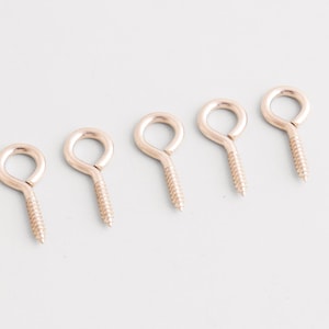 May include: A set of three ceramic mugs with a speckled, matte finish. The mugs are in shades of cream, light gray, and dark gray. Each mug has a simple, minimalist design, perfect for coffee or tea.