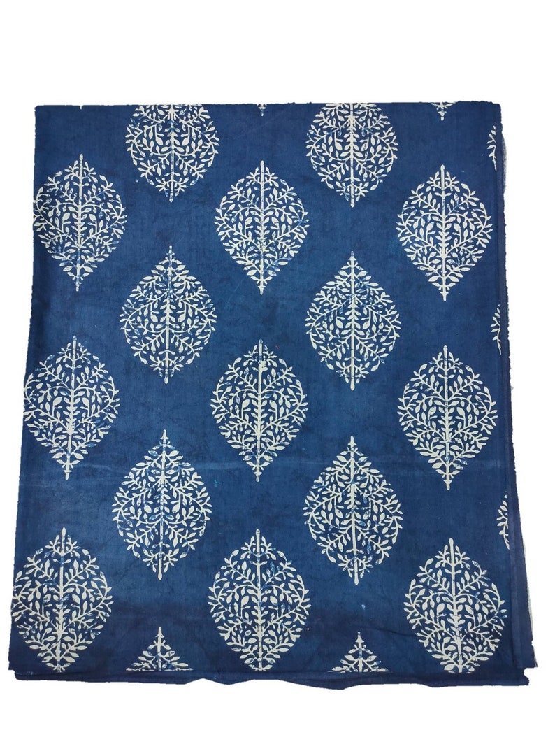 May include: A blue cotton fabric with a white leaf pattern. The fabric has a traditional Indian design.