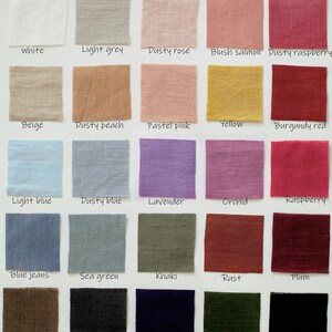 A collection of fabric swatches in various colors, including white, light grey, dusty rose, blush salmon, and dusty raspberry. Each swatch is labeled with its color name, showcasing a range of hues from light to dark.