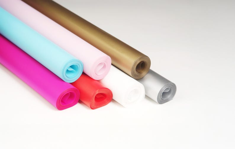 May include: Assortment of rolled tissue paper in various colors, including pink, blue, red, gold, silver, and white.