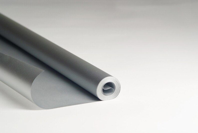 May include: A roll of silver wrapping paper is partially unrolled, showing the metallic sheen of the paper.