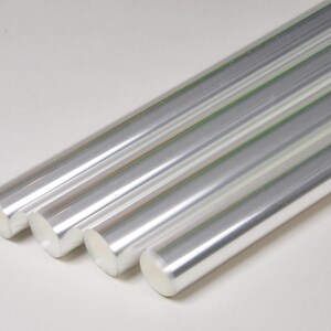 May include: Four silver metal rods, arranged in a row, with the ends of the rods overlapping.