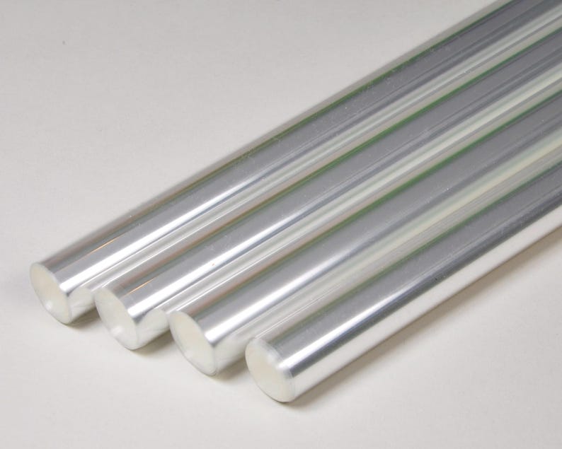 May include: Four silver metal rods, arranged in a row, with the ends of the rods overlapping.