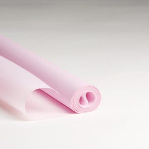 May include: A roll of light pink tissue paper, perfect for wrapping gifts or adding a touch of color to crafts.