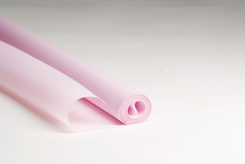 May include: A roll of light pink tissue paper, perfect for wrapping gifts or adding a touch of color to crafts.