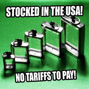 May include: A collection of silver-colored, rectangular flasks of varying sizes, each with a black cap and a small ring. The flasks are arranged on a green surface, with the text "STOCKED IN THE USA!" and "NO TARIFFS TO PAY!" in white.