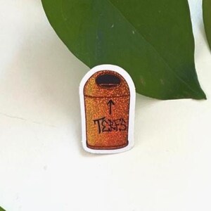 May include: A white ceramic mug with a black handle and the text "But First, Coffee" in a handwritten style. The mug is on a white surface. The mug is approximately 4 inches tall.