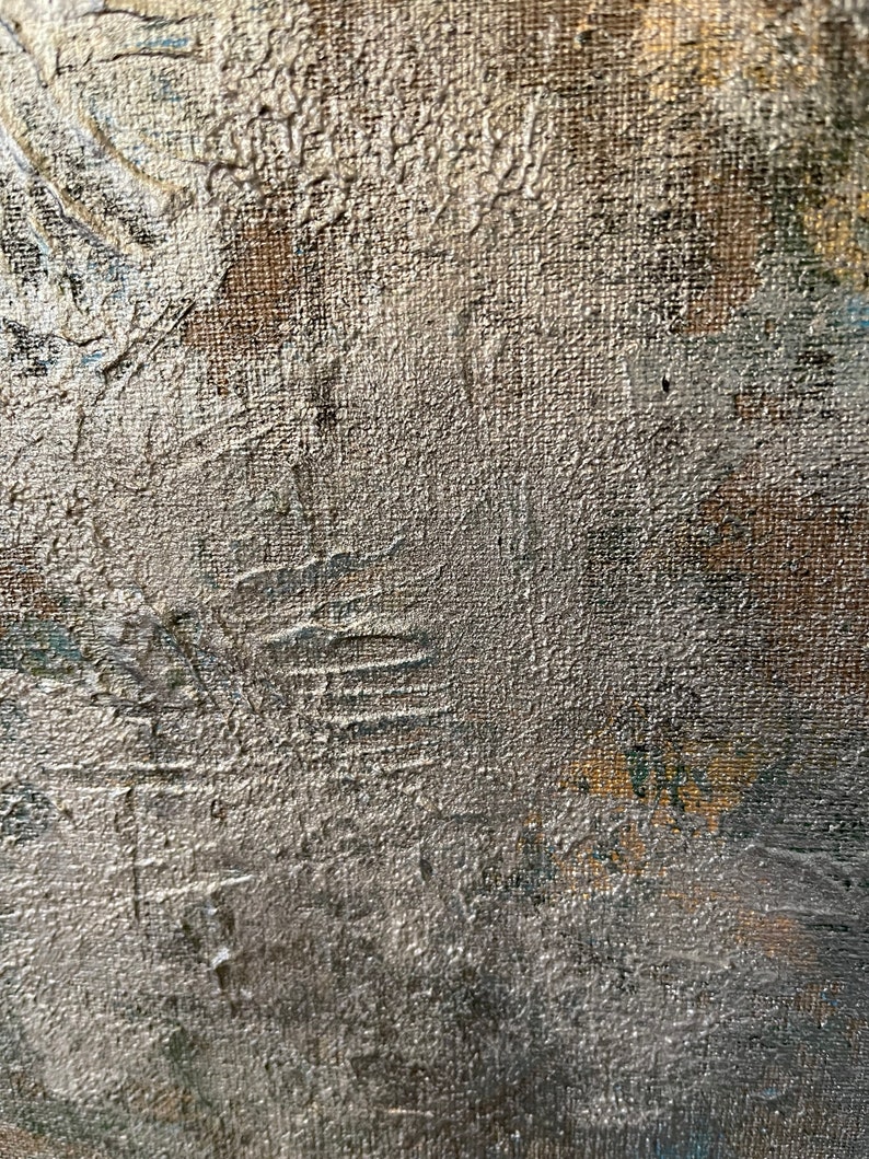 May include: Close-up of a textured, silver-colored canvas surface. The canvas has a rough, uneven texture, with visible brushstrokes and paint splatters. The surface is slightly darker in the lower right corner.