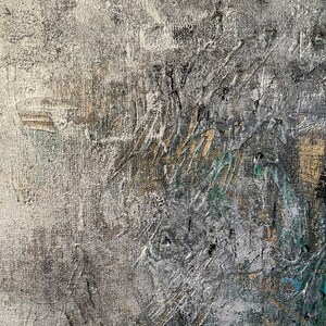 May include: Abstract painting with a textured surface. The painting features shades of gray, white, and gold with hints of green and blue.