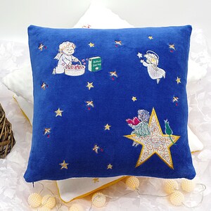 May include: Blue velvet pillow with embroidered images of angels, stars, and a book with the text "Hello Sunshine".