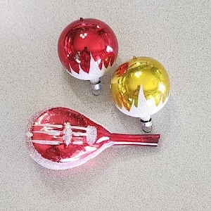 3 Vintage Christmas Ornaments. 2 West Germany Snow Glitter Top Glass Round 1 1/2 inch and 1 Frosted Music Banjo Mandolin 3 1/2 inches long.