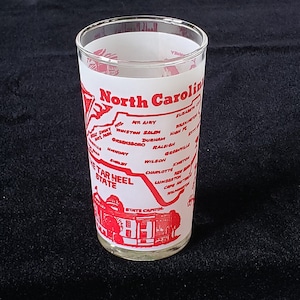 Vintage MC State of NORTH CAROLINA Souvenir Tumbler Drink Glass Frosted with Red Graphics. Holds 8 ounces and is in very nice condition.