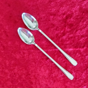 Vintage 1938 ARGYLE 2 Iced Tea Spoons by Argyle Silver Plate. Nice used condition with light heel marks from storage. 7 1/2 inches long.