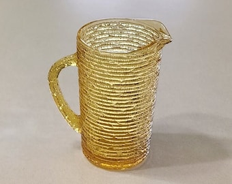 Mid Century Anchor Hocking Soreno 7 inch tall Juice Milk Pitcher in Yellow Amber. Holds about 26 inches. No wear or damage.