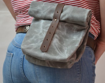 Waxed canvas lunch bag with leather belt loops. Small waterproof bag with rolled top and leather closure strap.