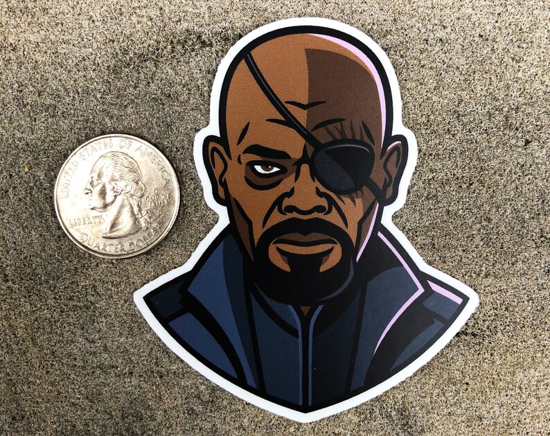 May include: A sticker featuring a stylized illustration of a bald man with an eyepatch and a goatee. The sticker is next to a U.S. quarter for size comparison. The man's skin is brown, and he wears a black eyepatch and a dark blue jacket.