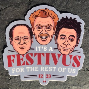 May include: A sticker featuring three cartoon faces of characters from the TV show Seinfeld. The sticker has the text "It's a Festivus for the rest of us" and the date "12 23".