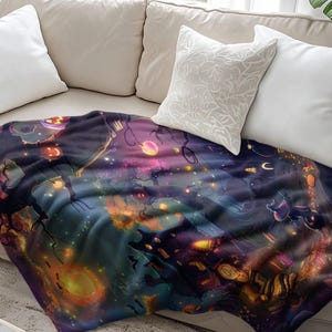 Halloween blanket design featuring a magical haunted house surrounded by glowing pumpkins, twinkling lights, bats, and colorful autumn trees, with a small witch standing under a vibrant night sky.