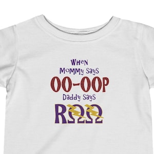 May include: White baby t-shirt with a purple and brown graphic that says "When Mommy Says 00-00P Daddy Says R222"