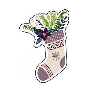 May include: A white Christmas stocking with a purple and white geometric pattern and a snowflake design. The stocking is filled with a bouquet of green pine branches, white berries, and a dark red flower.