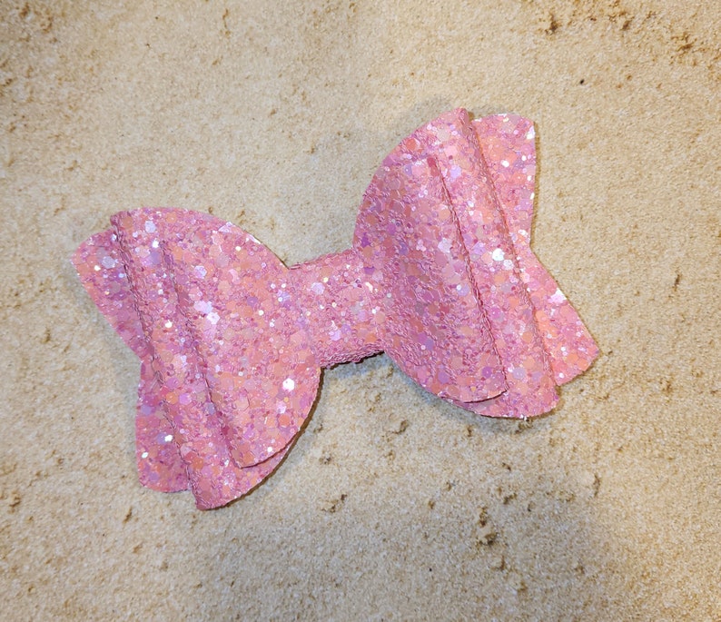 Super sparkly non-shed perfect pink glitter girls' hair bow. Available in multiple sizes and styles.