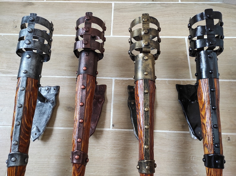 May include: Four decorative wall-mounted torch sconces with metal accents. The sconces are made of wood and have a rustic finish. The sconces are in different colors, including black, brown, and gold.